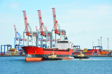 Tugboat assisting bulk cargo ship