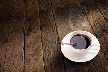 cup of coffee on wooden background.