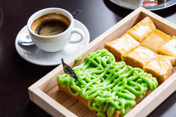 Bread custard on wooden plate and coffee