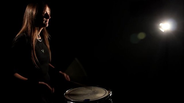 Woman Drummer Playing In A Dark Room