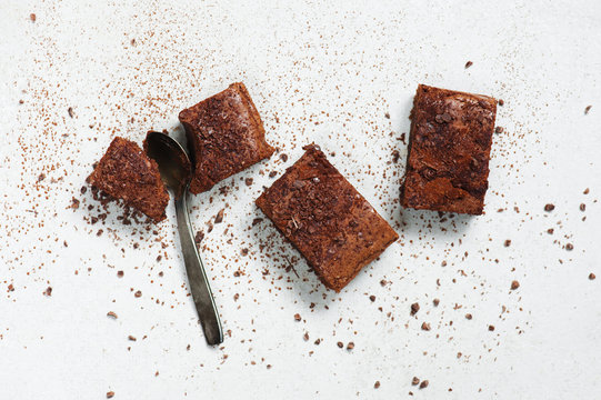 Brownie pieces sprinkled with chocolate chips and cocoa