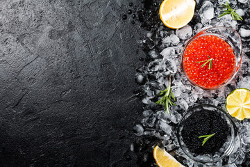 Glass bowl with red and black caviar - obrazy, fototapety, plakaty