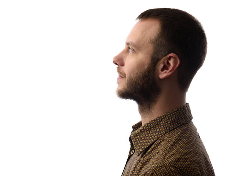 Side view of young bearded man isolated