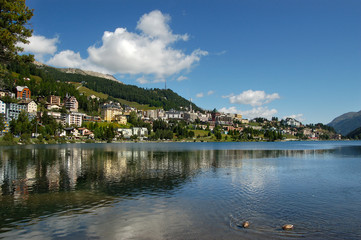 Fototapeta na wymiar Cityscape of Saint Moritz with lake, blue sky and clouds. Engadin, Switzerland, Europe