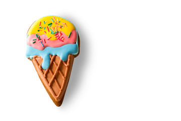 Cookie shaped as ice cream. Colorful biscuit on white background. Good taste and bright colors. Glaze made of sugar.