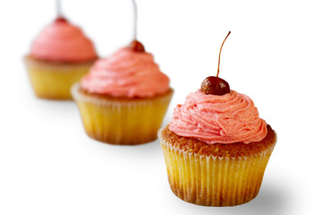 Cupcakes with pink frosting. Baked desserts on white background. Joy has a flavor. Discover the wonders of cooking.