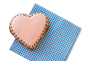 Top view of heart cookie. Glazed biscuit on checkered napkin. Love of a gourmet. Stay true to your feelings.