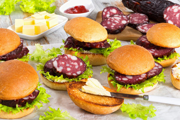 sandwiches with butter, lettuce and slices of smoked sausage