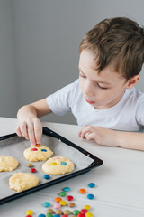 The child prepares homemade Christmas cookies