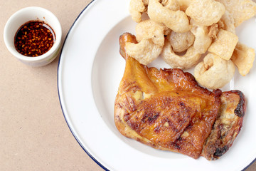 Streaky pork with crispy crackling and Grilled chicken leg with spicy sauce in small cup on wooden...