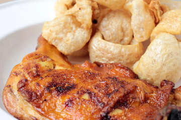 Streaky pork with crispy crackling and Grilled chicken leg with spicy sauce in small cup on wooden background. close-up. horizontal view from above. Thai Food