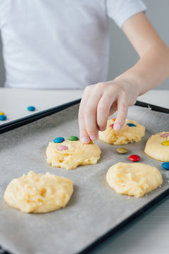 The child prepares homemade Christmas cookies