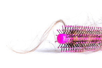 Comb hair with tufts, bundle of hair, lots of hair on the hairbrush close up on a white background