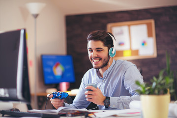 Fototapeta premium Businessman playing videogames in his office