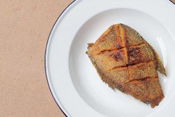 The fried in white dish on wooden background, delicious thai food