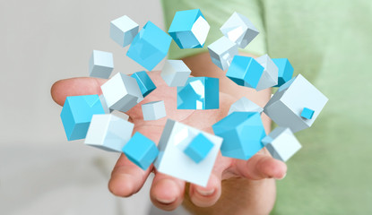 Businessman holding flying blue shiny cube 3D rendering