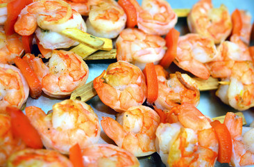 Appetizing grilled queen prawn tail brochettes.