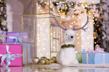 Christmas and New Year's toys on the Christmas tree and deer on the background of Christmas decorations