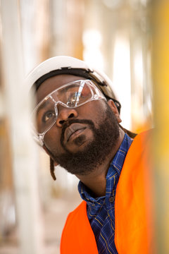Close up of African american construction worker. Low angle view