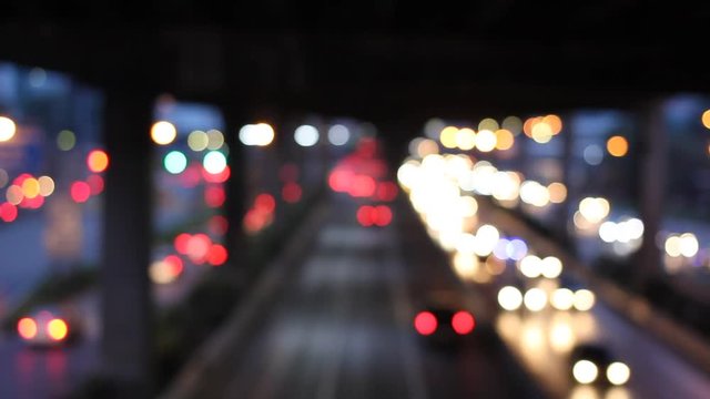Abstract circular bokeh motion lens blur backround of city and street light on rainy day at night time in Thaialnd