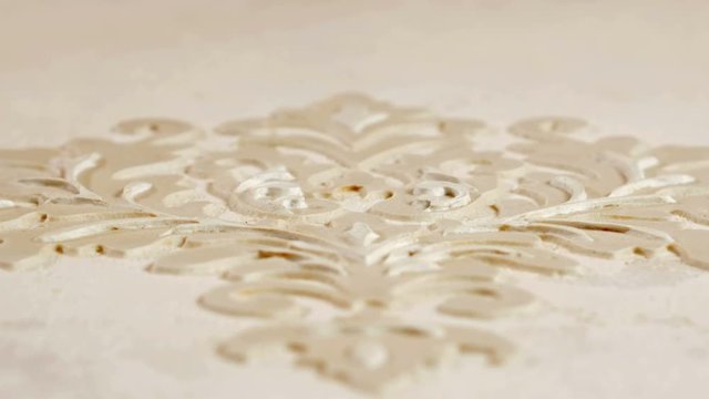 Texture of working Stucco pattern white color wall. Multi-layer decorative plaster plaster. Macro shot with moving camera