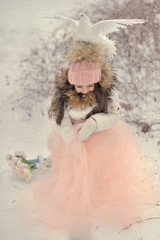 snowy winter and a girl in a cap with doves