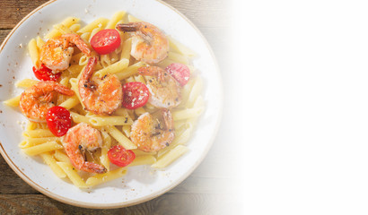 Penne pasta with shrimps and tomatoes.