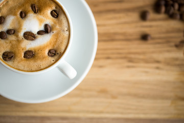 close up Latte Art cup cafe with coffee beans.