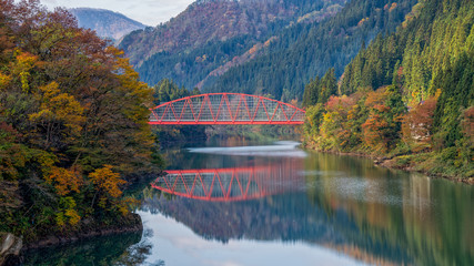 Fototapeta na wymiar Red bridge at the Tadami river, Fukushima, Japan.