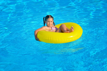 Real toddler girl at swimming pool