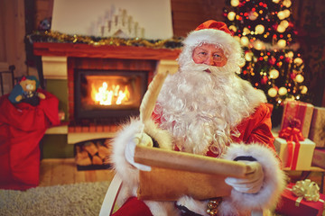 Santa Claus reading  children wishes for Christmas