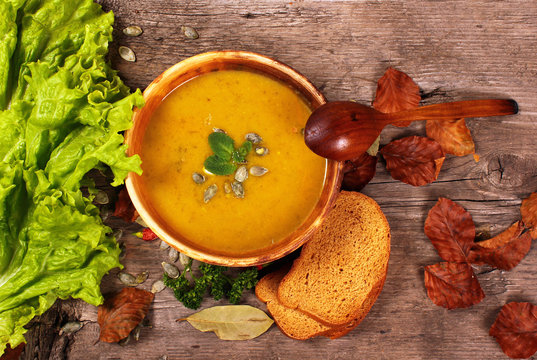 Pumpkin Soup With Spoon Bread And Salad Leaves