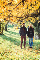 Fototapeta premium Young couple in autumn park