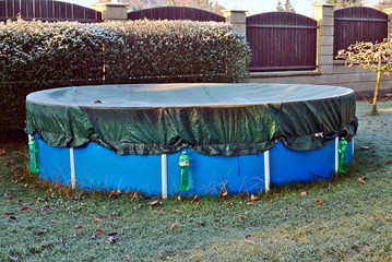 Garden pool in the winter covered with frost