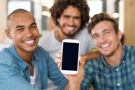 Friends showing smartphone