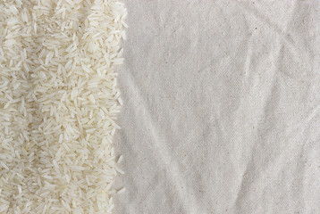 rice on old wooden table texture background. over light and use a soft focus