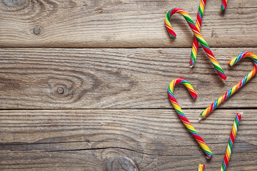 Christmas Candy Canes on old wooden table. Space for text