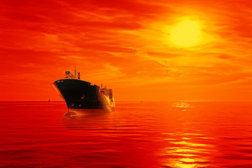 Obraz premium Silhouette of the tanker ship on red sunrise.