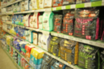 Packs of animal food on pet shop shelves