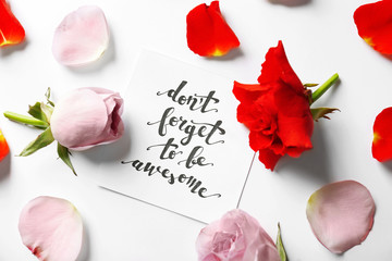 Quote "Dont forget to be awesome" written on paper with petals and flowers. Top view