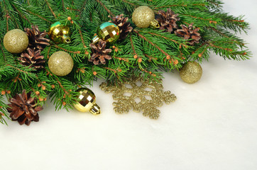 Christmas decorations and spruce branch and cones on a white