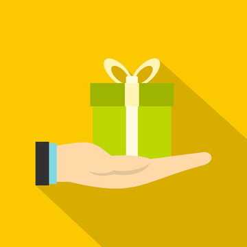 Gift box in hand icon. Flat illustration of gift box in hand vector icon for web design