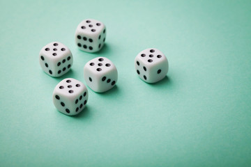 White dice on green background. Gambling devices. Copy space for text. All number five. Game of chance concept.