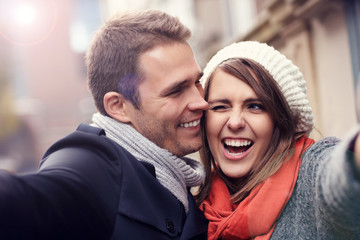Fototapeta premium Young couple taking selfie in the city