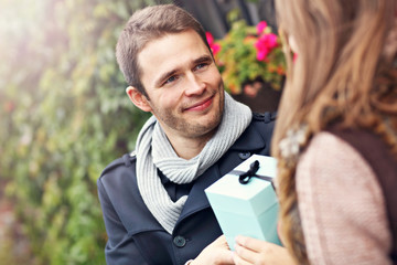 Fototapeta premium Young couple with present in the park