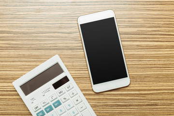 Office table with  smartphone on it. View from above