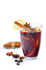 Cup of hot wine with spices on white background