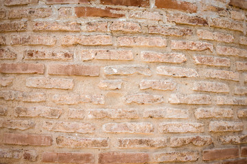 Wall of old broken bricks. Textured background. Toned