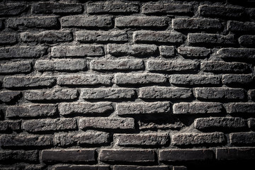 Wall of old broken bricks. Textured background. Toned