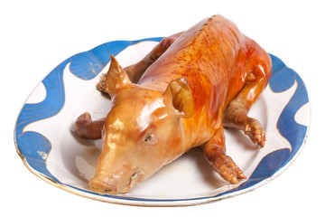 Roast suckling pig in the old porcelain dish
